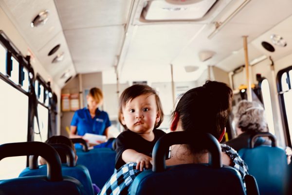 Child and mother riding bus